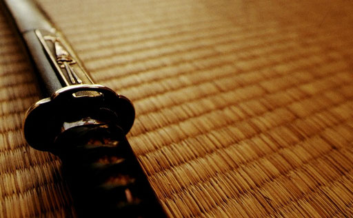 A wakizashi -- a Japanese short sword -- at rest on tatami.