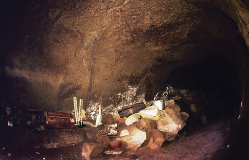 Recent memorials are placed alongside remnants of the fighting at a cave entrance, Iwo Jima.  The sides and ceiling still show charring from a US Marine flamethrower assault.