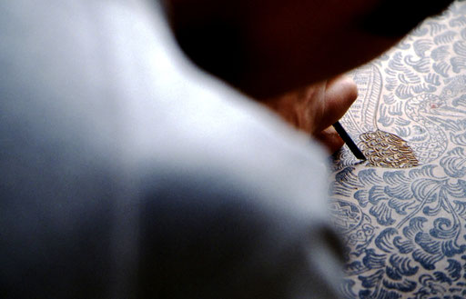 A woodblock print craftsman begins the carving on a new block.  Tokyo, Japan.