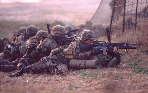 The first wave of helicopter-borne Marines prepares to move inland from the beach at Tok Sok Ri, South Korea, during a bilateral/joint Foal Eagle exercise. Their task is to take and hold the beachhead for the seaborne forces that will follow.