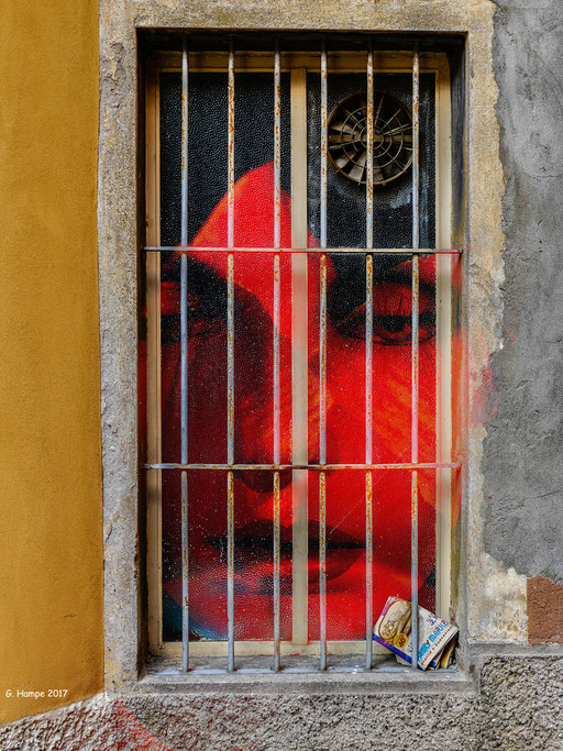 The red face behind the old window