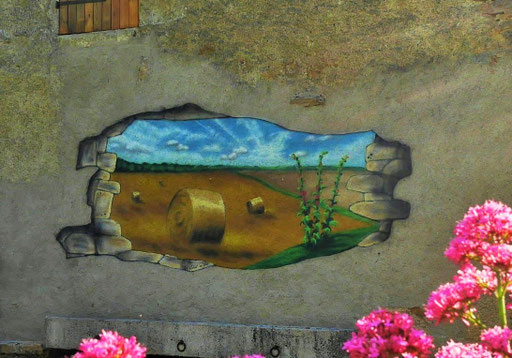 trompe-l'œil représentant une ouverture dans le mur vue sur un champ de blé, par l'artiste peintre Coron Thibaud