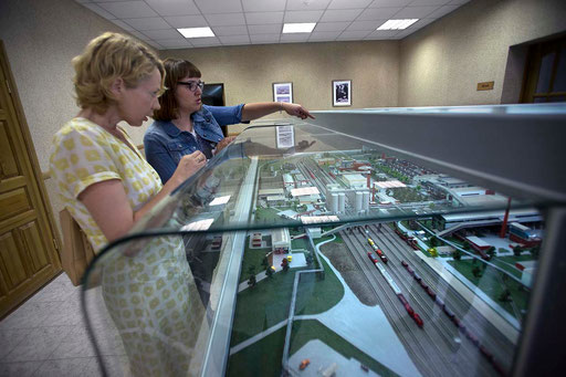 Natalya Starodubets (with glasses), UCEE Economist of the International Programs Department, with Head of the Environmental Department of 'Sukholozhsk Cement Plant' (SCP), looking a plastic model of SCP made by workers of the factory.