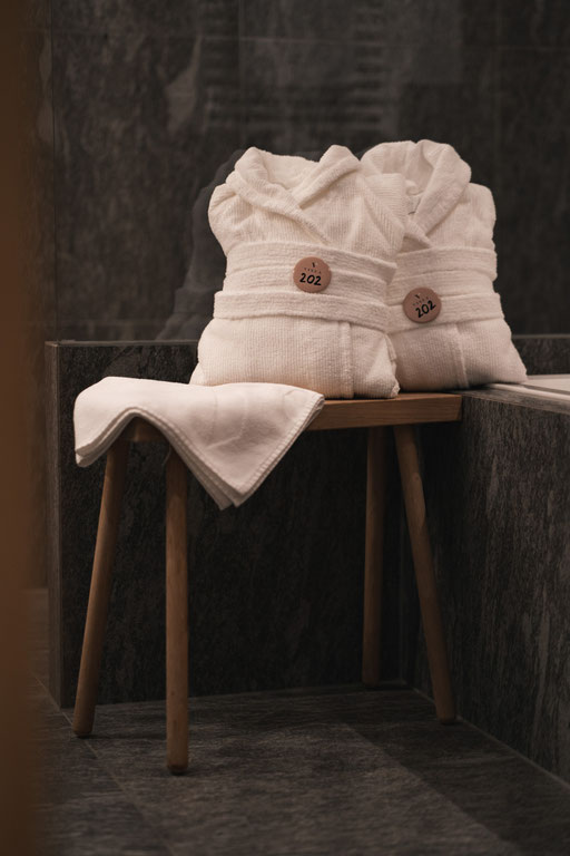 Bathrobe draped over a chair at VINEA Suites & Apartments