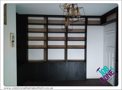 Bookcases with cupboards; all custom built to fit the space.