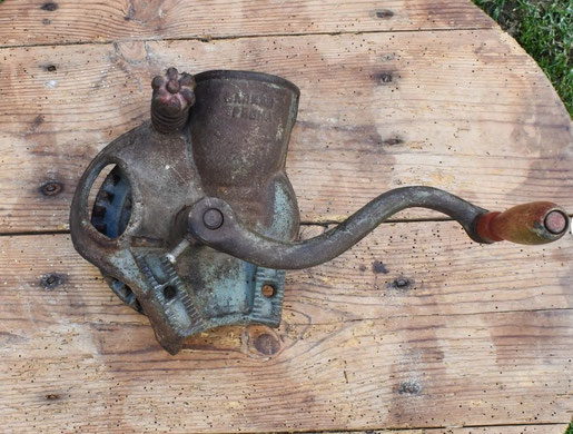 Typical old mounted corn grinder.