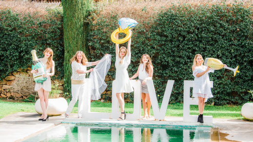 Group of woman celebrating bachelorette party by a pool