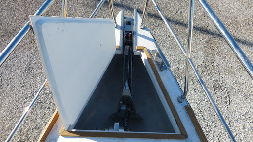 Deck of the semi displacement motor boat with a folding anchor platform