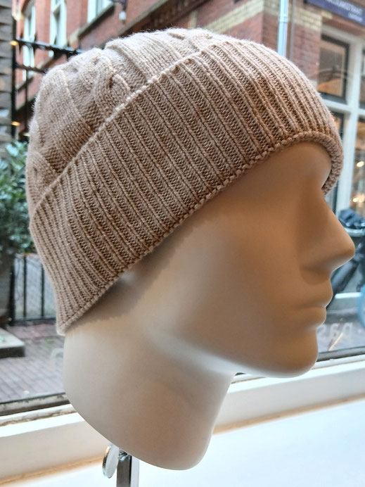 Cashmere knit hat styled on man head.
