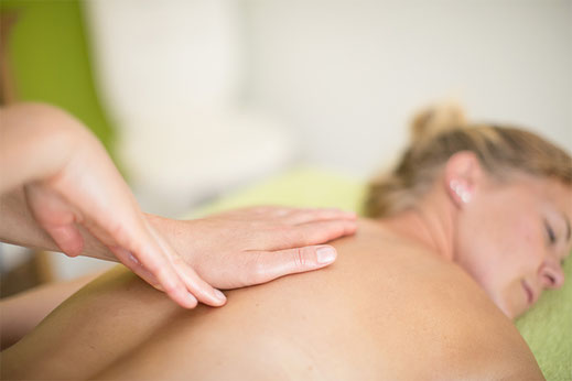 Eine Frau wird mit einer ayurvedischen Einölung behandelt, der Abhyanga