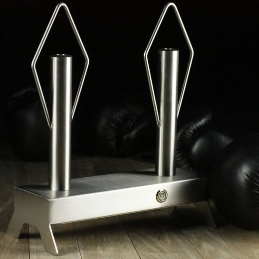 stainless boxing glove dryer on a wooden surface