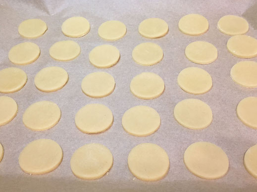 cutting out button shaped cookies