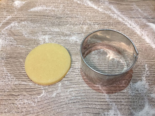 cutting out button shaped cookies