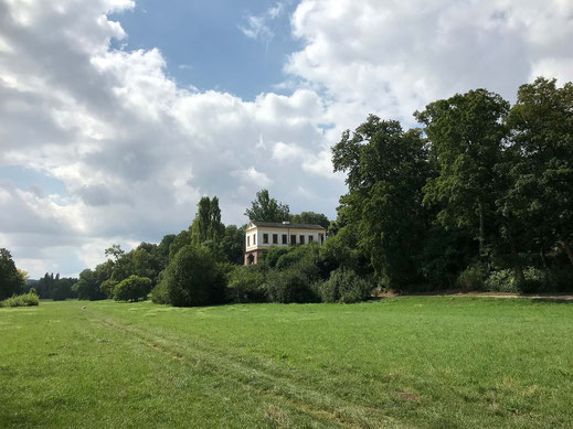 Photograph of the Roman House above the large meadows of the park on the river Ilm