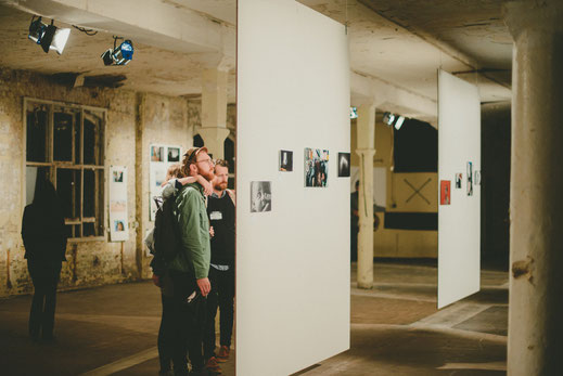 a group of people watching the exhibition