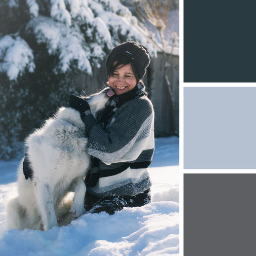 Hund und lachende Besitzerin im Schnee