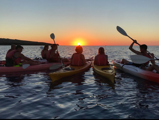 Group of Kayakers watching sunset