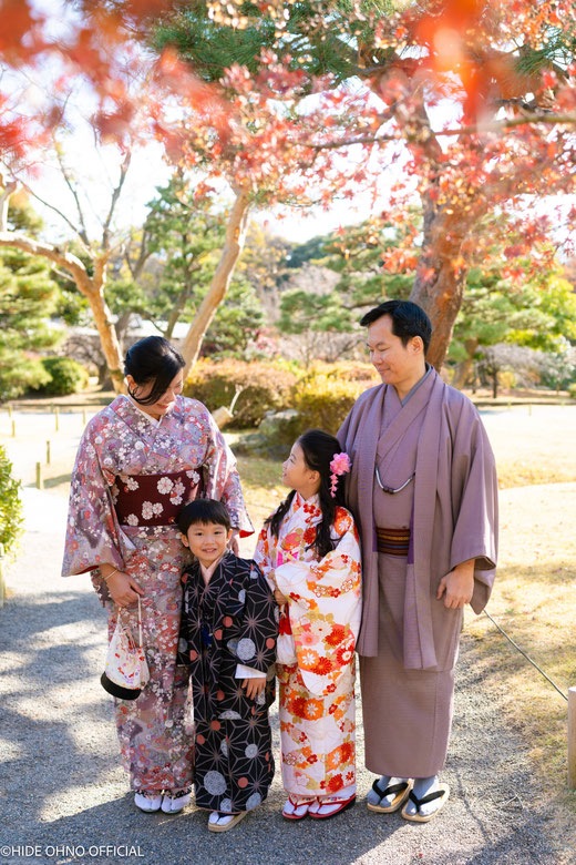 Family in traditional kimonos enjoying autumn colors in Asakusa — warm and authentic Japan feel.