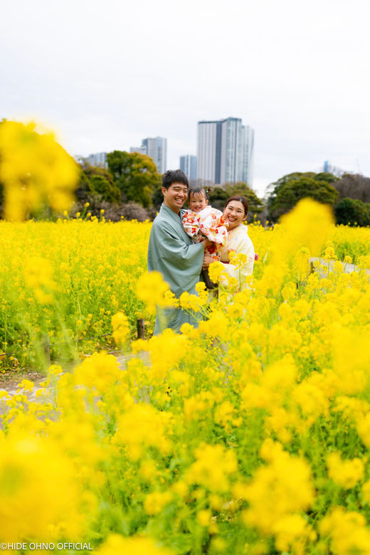 Family smiling together in a Tokyo flower field, wearing kimono and enjoying a relaxed photoshoot.