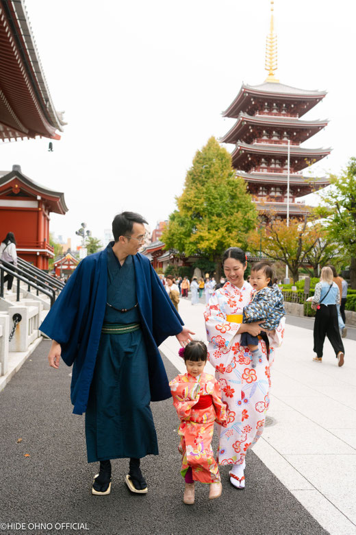 Family walking together near the pagoda at Senso-ji Temple in Asakusa, wearing kimono and smiling during their Tokyo trip.