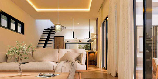 Bright open-plan living room with large sliding doors overlooking the pool in this Sanur villa.