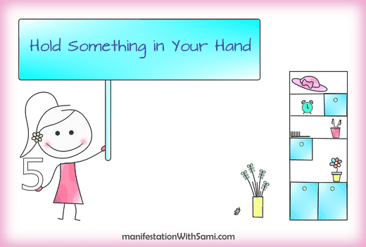 Technique 5 to boost your present moment awareness is holding something in your hand.