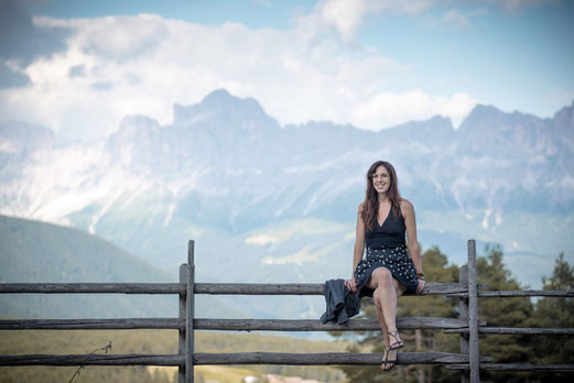 Irene infront of Rosengarten, part of the Dolomites in South Tyrol, Italy