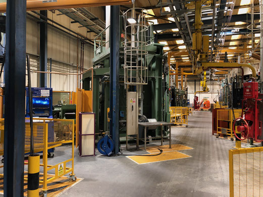 Hot metal forming presses to fabricate jet engine fan blades.