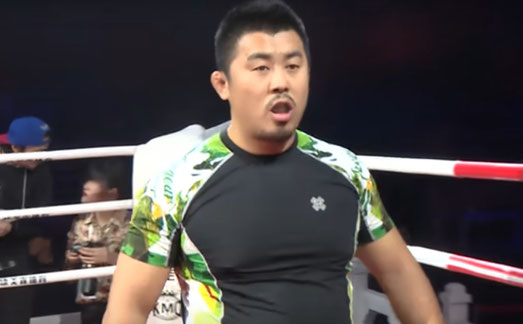 Auf dem Bild ist Xu Xiaodong zu sehen, wie er im Boxring steht.