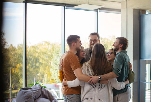 A group of expats and locals sharing a joyful moment, representing the authentic friendships expats can create by learning Spanish.