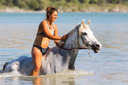 Viviane riding and swimming with the horses.