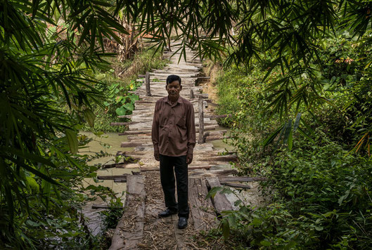 Peung Thy near sugar cane fields he used to own near Trapaing Chour. He was once part of an elite bodyguard unit formed to protect Mr. Hun Sen, but his land was taken to make way for a sugar plantation owned by a Cambodian tycoon. (Credit: Adam Dean)