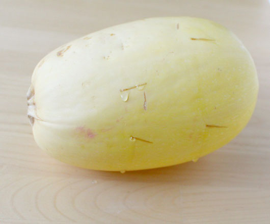 use a sharp knife to carefully poke holes around the spaghetti squash before cooking it whole.