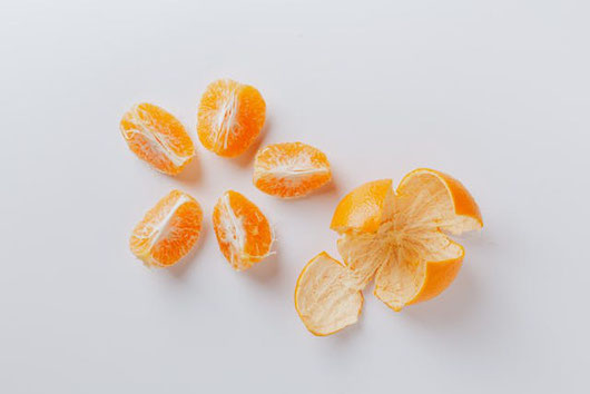 キッチンのカウンターに並べられた野菜たち。たまねぎ、にんじん、ピーマン、トマト、かぼちゃ、ブロッコリー、じゃがいも。計量カップに活けられたハーブ。