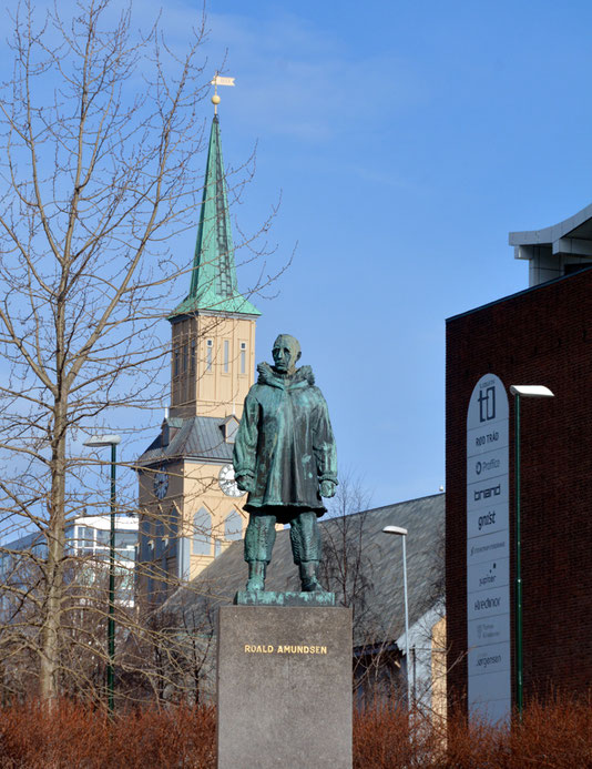 Bronze statue of Roald Amundsen (1872-1928) and the Domkirke, Tromso. He died in a plane crash on a rescue mission somewhere north of Tromso in the Barents Sea. His body was never recovered. 