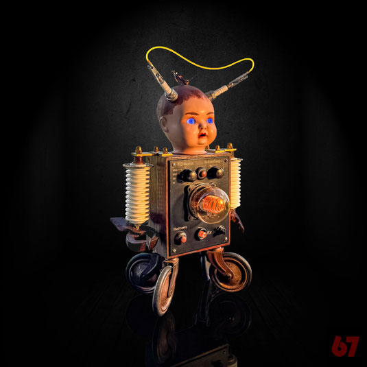Intuition is an assemblage artwork with historical parts: Doll head, spark plugs, porcelain insulators, devices, glow bulbs 