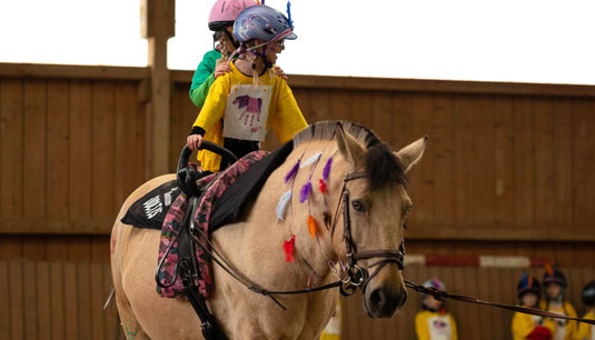 Impression der Voltigiervorführung Herbstfest 2022, Voltigierpferd mit Kind