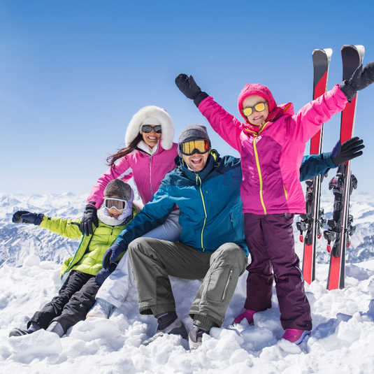 Family group photo on ski holiday in the snow