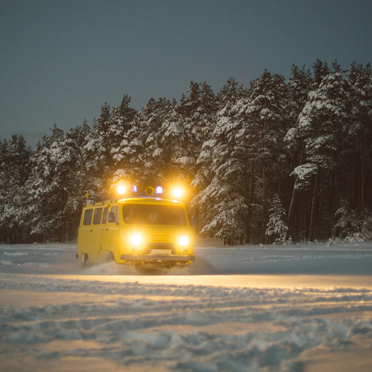 Taxi van driving in snow