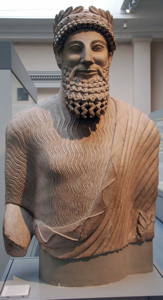 Colossal limestone statue of a clothed bearded man from the sanctuary of  Apollo-Reshef in the city-kingdom of Idalion 450 BC: British Museum wearing chiton (short-sleeved tunic) and himation (cloak)