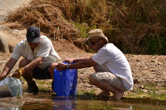 M and Reeve collecting water in Purus Canyon in the Hoarsib River