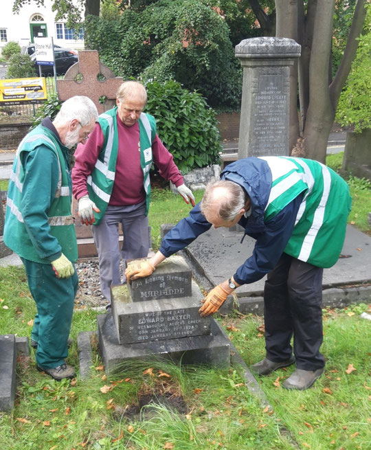 Volunteers from Acocks Green in Bloom who are working on the graves at St. Mary's put the final touches to repositioning the Baxter memorial