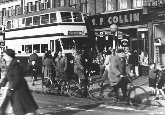 A bus accident c. 1955. Amazingly the shops were not hit (Mike Wood). S.F. Collin was at 1176.