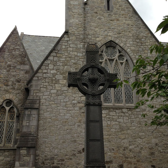 Celtic cross before a church.