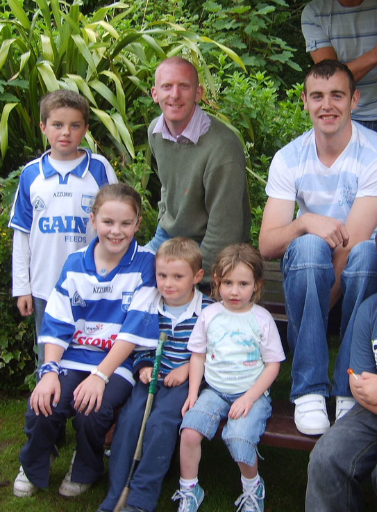 Young Daniel& Meada with some friends and some Hurlers on a ditch