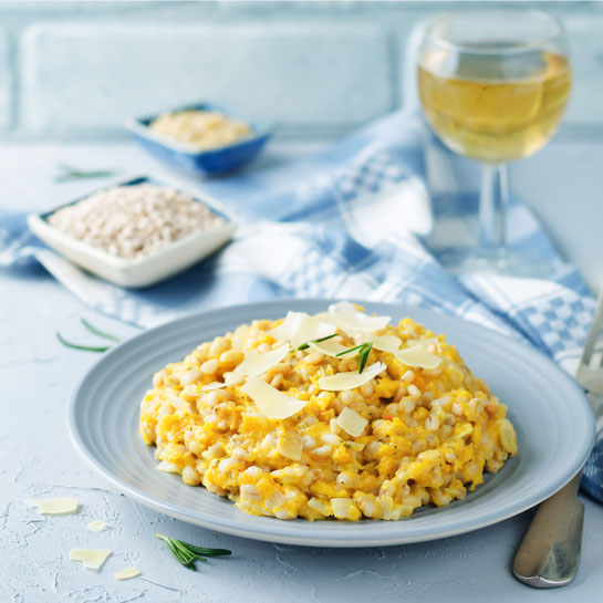 Roasted pumpkin and Pearl Barley Risotto on a stone background. toning. selective focus
