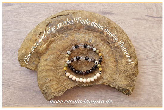 Die Aufnahme zeigt eine versteinerte Schnecke in der mittig zwei Themenarmbänder befinden. Das Themenarmband - eins sein und eins werden. Finde deine innere Balance, können bei Svenja Lampke bestellt werden.