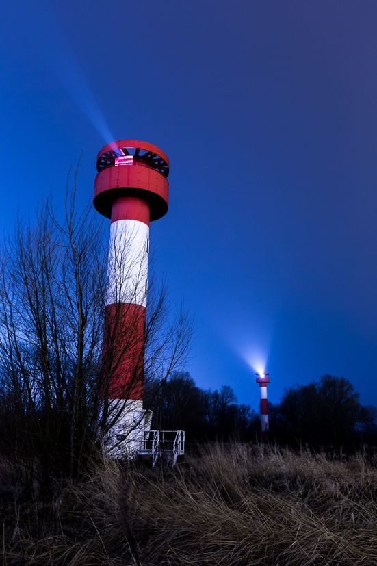 Two light houses at night in Hamburg harbour