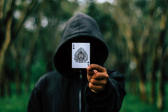 Person holding a playing card