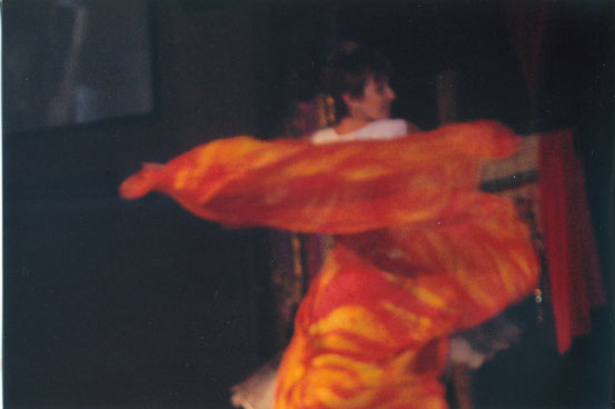 Woman dancing with a silk that looks like fire